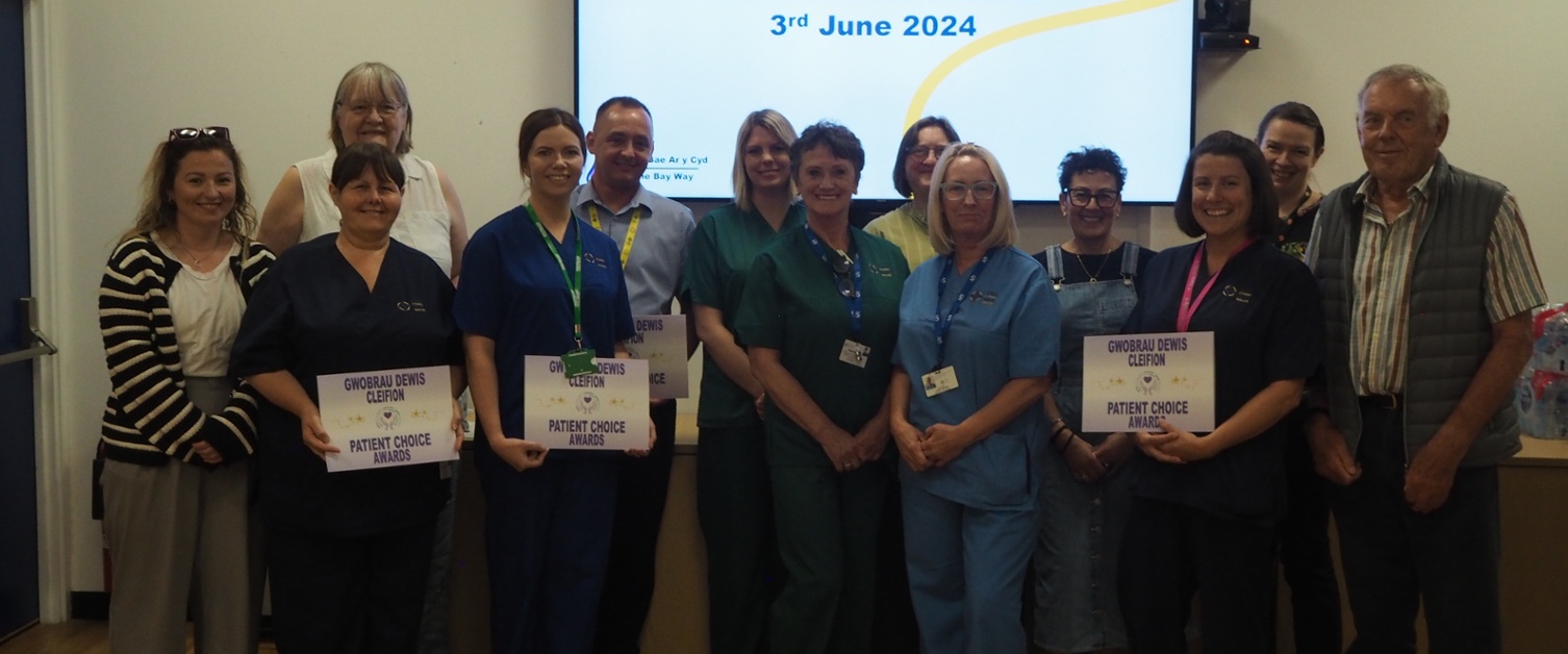 Hospital staff pictured holding award certificates, with patients next to them