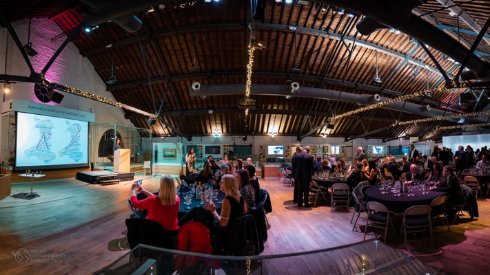 Image shows people sat around tables