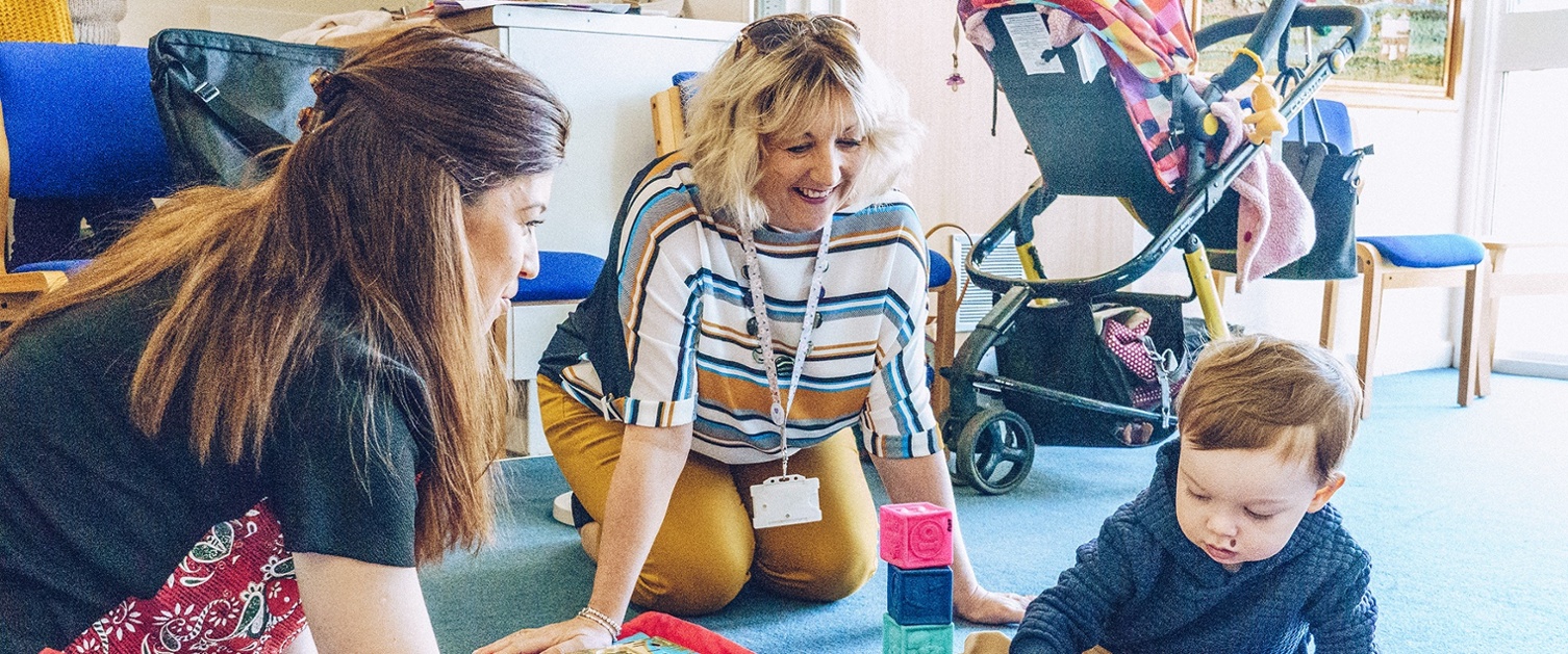 An image of a child, his mother and Health Visitor.