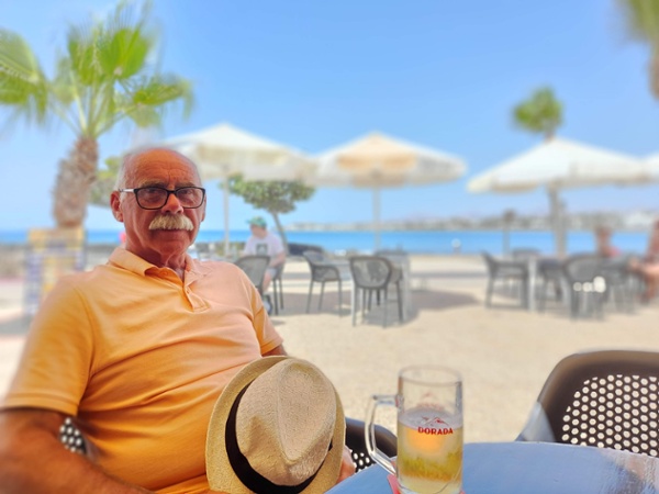 David sat at a beach on holiday
