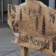 A wooden sign outside Taith Newydd.