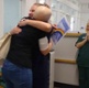 Image shows a patient hugging a hospital nurse.