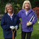 Image shows three volunteers standing in a garden.
