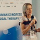 Image shows a conference delegate talking on stage.