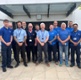 Image shows a group of men standing in front of a building