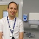 Image shows a doctor smiling into the camera.
