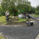 Image shows men digging up turf