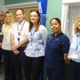Image shows a group of clinicians in a hospital room.