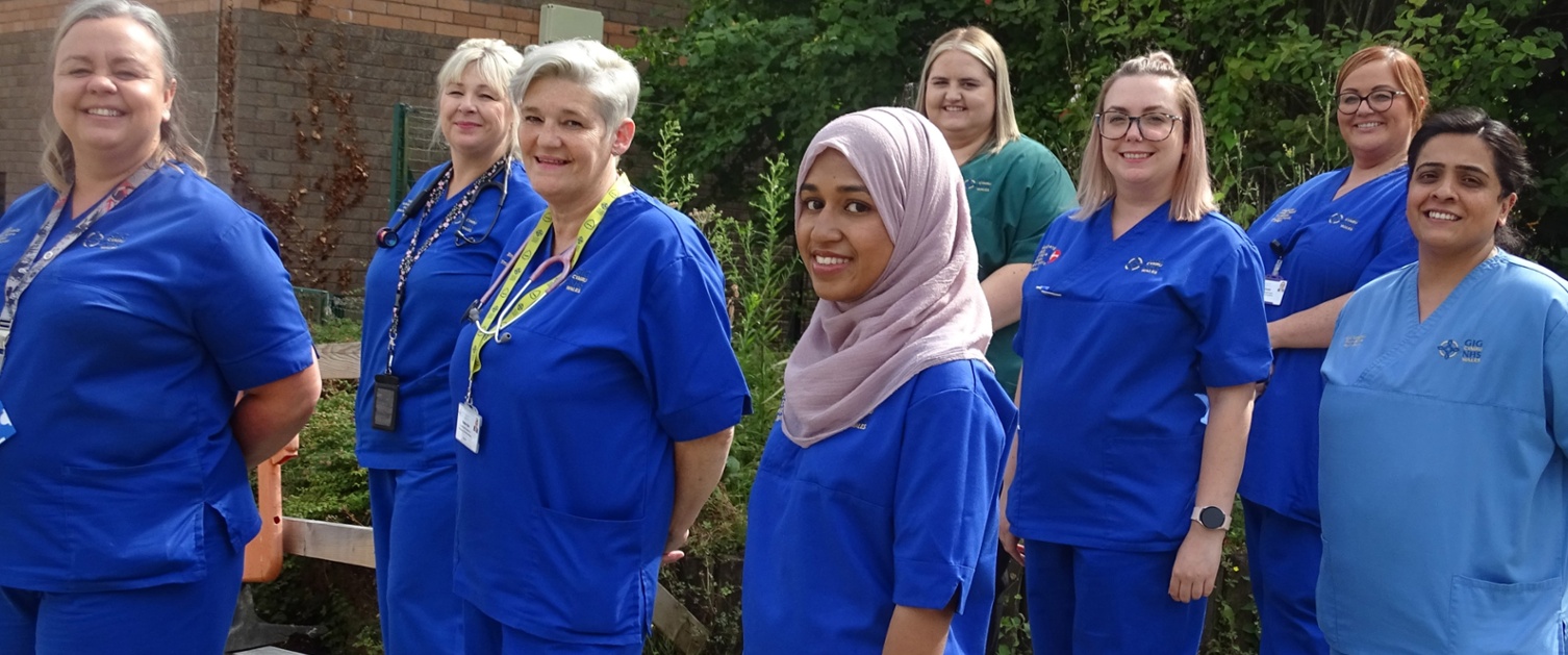 A group of nurses outside a hospital building