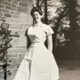 Image shows a nurse in a uniform standing outside