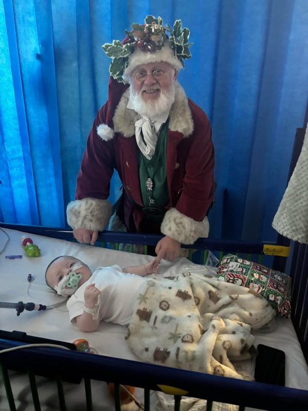 Santa, pictured holding a baby