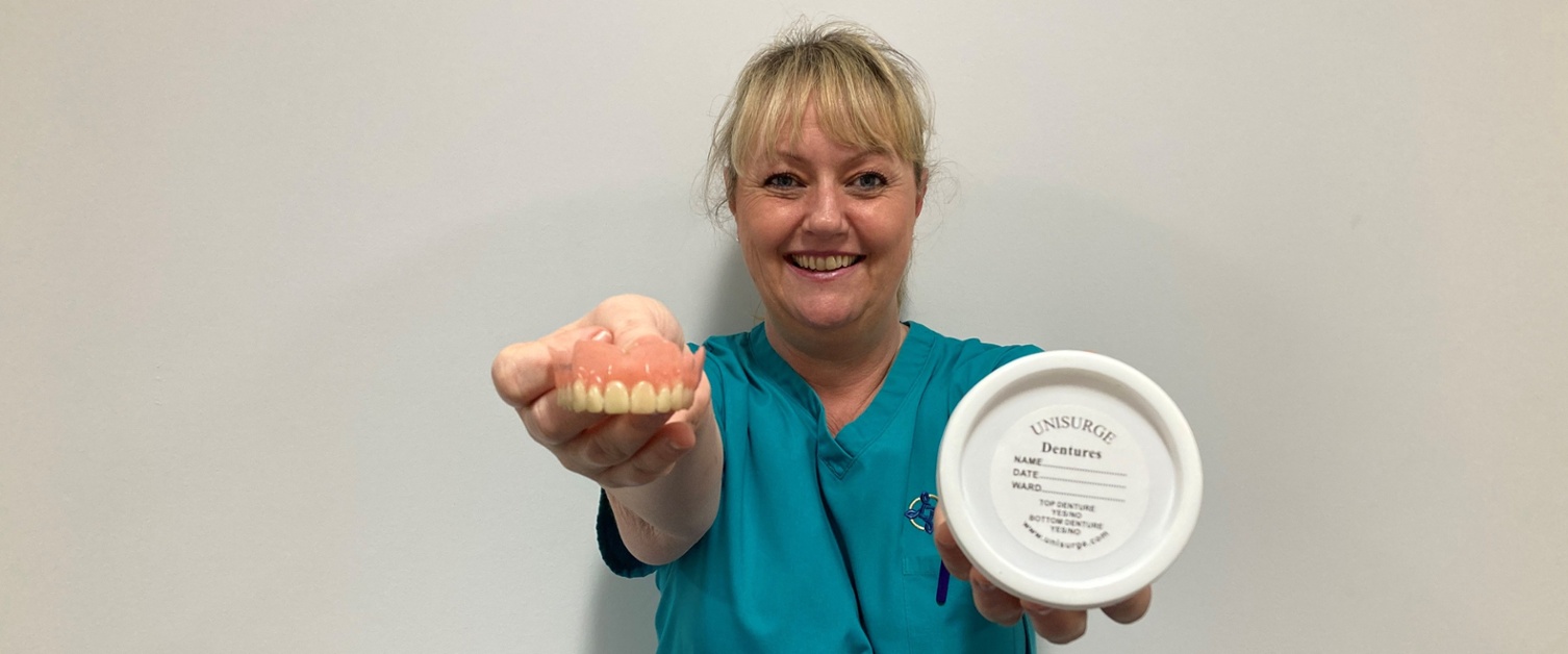 Image shows a woman holding dentures and a pot