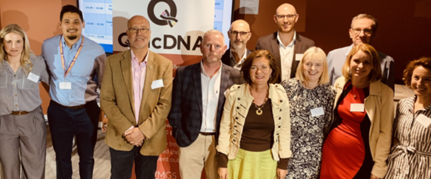 A large group photograph featuring the QuicDNA project team, partners and First Minister