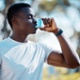 Image shows a man using an inhaler