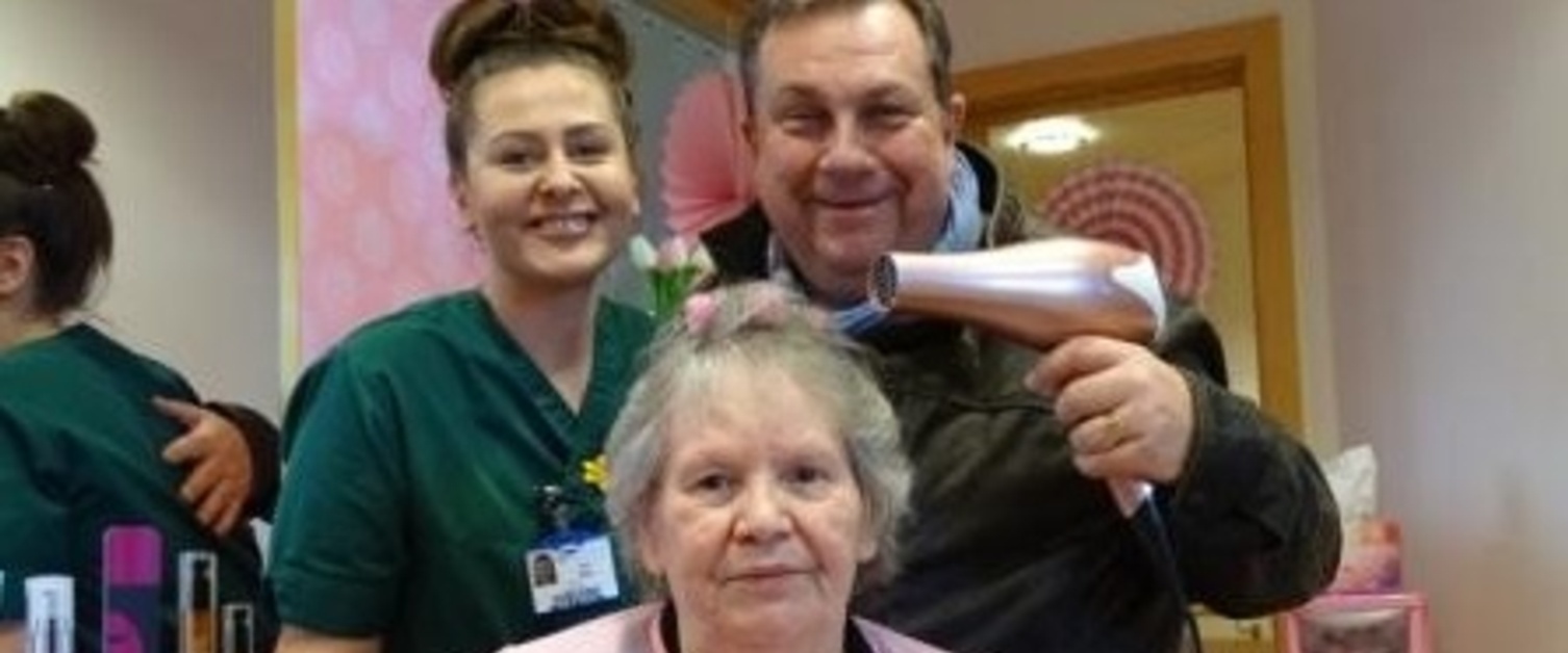 Kev Johns with a staff member and patient smiling at the camera in Cefn Coed Salon Serenity.