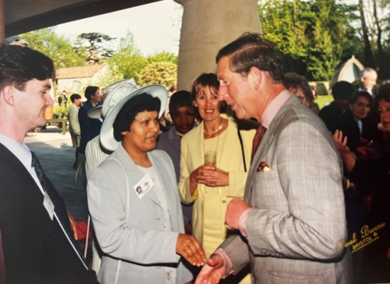 Image shows a woman shaking hands with Prince Charles