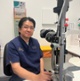 Image shows a man sitting next to a eye testing device