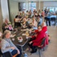 A group of women sat at tables holding mugs