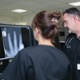 Staff examining an x-ray on a computer screen