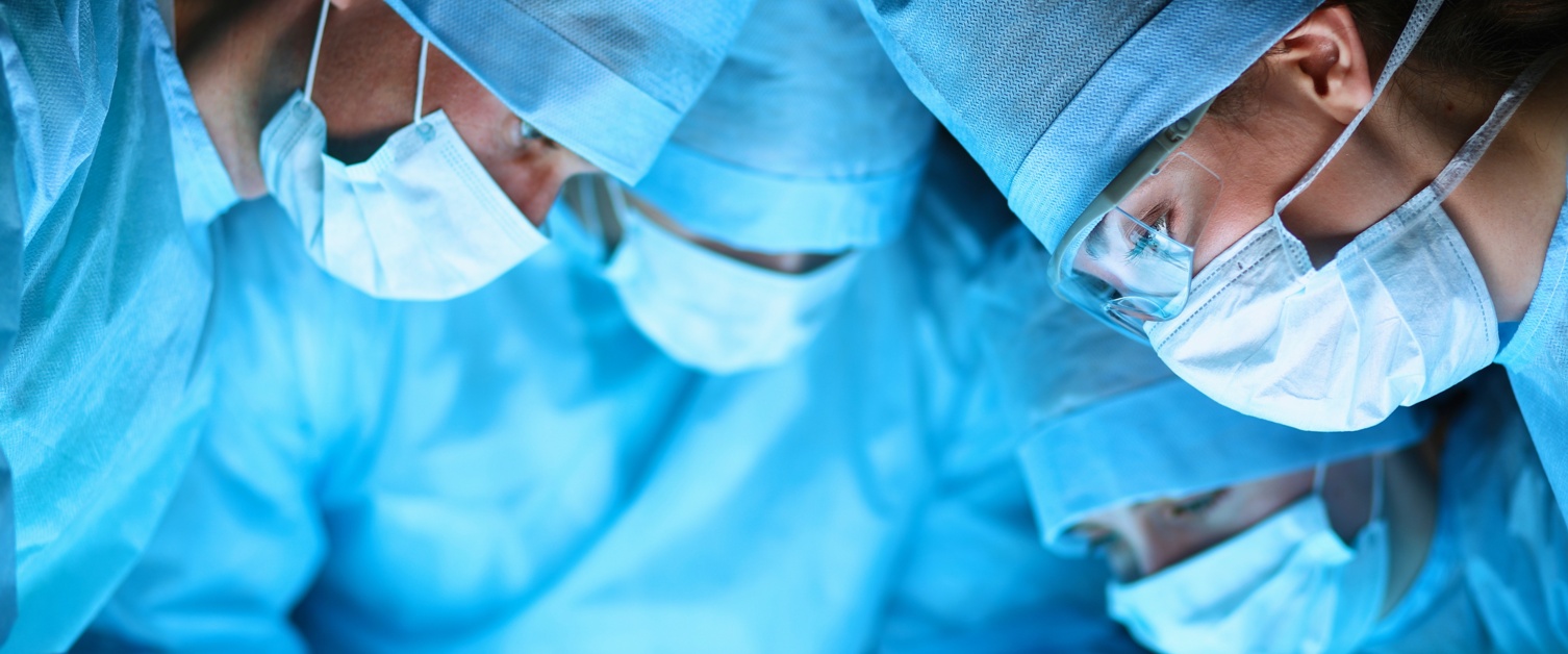 Surgeons with face masks on working