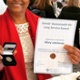 Image shows a woman holding a certificate