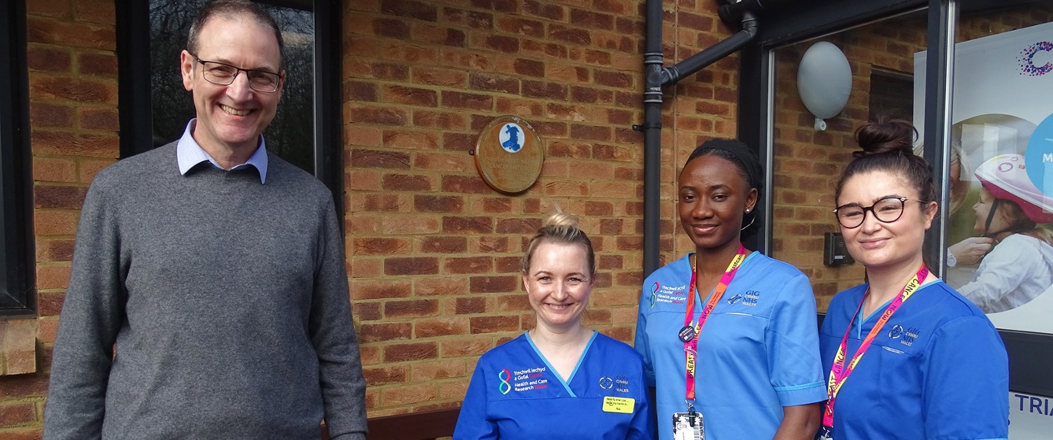 Image shows a group of hospital staff outside a building.