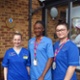 Image shows a group of hospital staff outside a building.