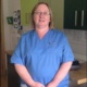 A neonatal staff nurse smiling at the camera