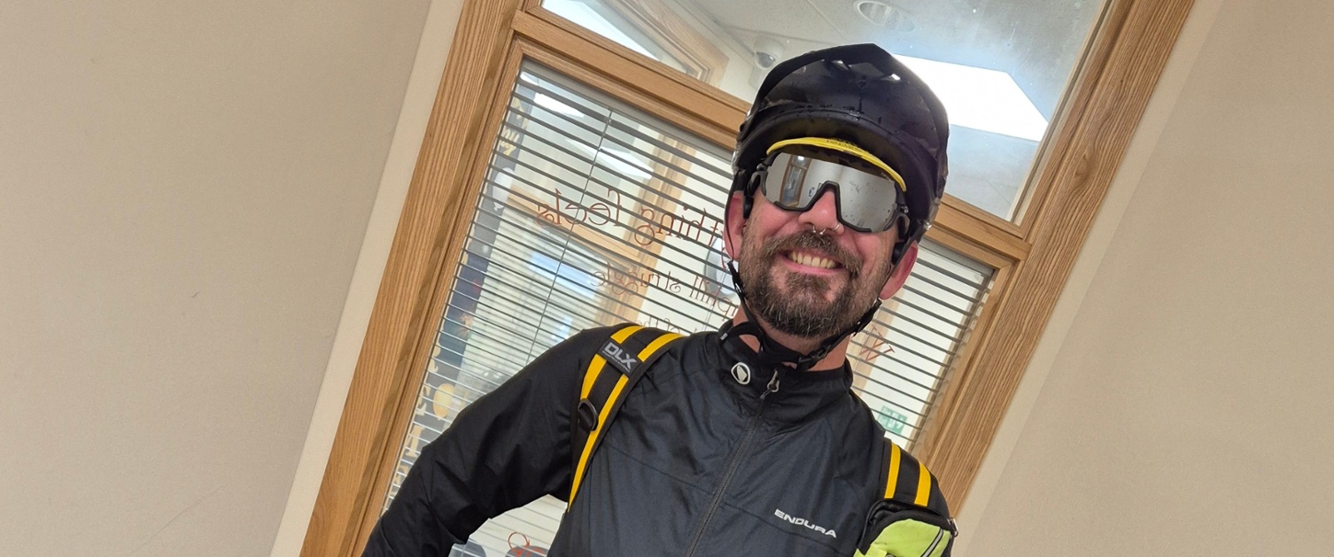 Image shows a man wearing cycling attire