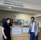 Kelly and Mohammed stood in front of a desk