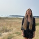 Jordanne stood near the beach with Mumbles in the background