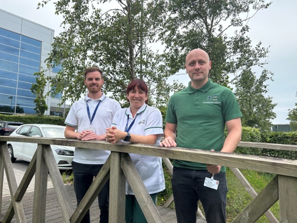 Anthony, Aimee and Alex standing on a footbridge