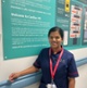 Image shows a woman standing next to a poster display