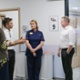 A doctor explaining something to a politician while a nurse looks on