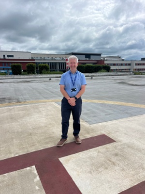 Image shows a man standing on a helipad