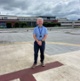 Image shows a man standing on a helipad
