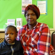 Little boy pictured sitting next to his mum