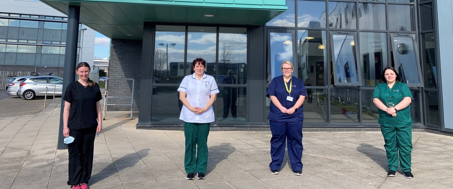 Members of the team stood outside the GP surgery