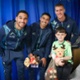 Image shows a three men and a child