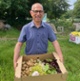 Image shows a man with a box of vegetables