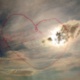 An image of the sky with a red heart in it