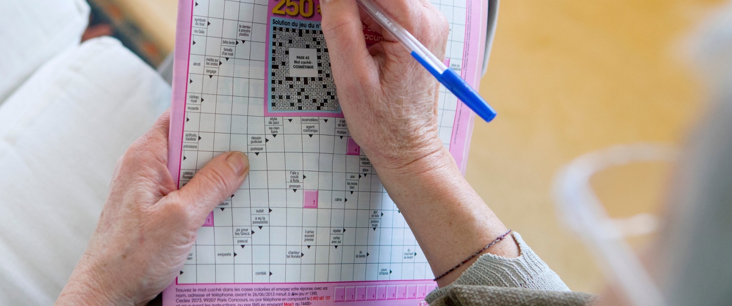 A picture of a woman doing a puzzle