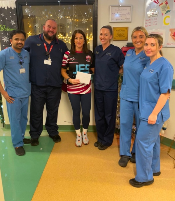 Cheryl stands with the coronary care unit team.