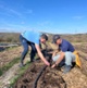 Image shows two men at a farm