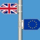 A sign with a Union Jack Flag and European Flag facing opposite directions.
