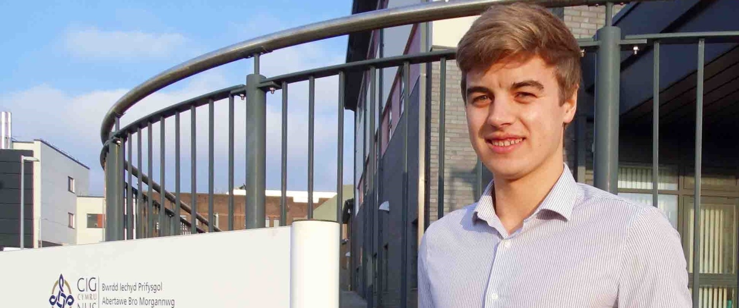 Jonathan Howard standing outside the Rehabilitation Centre in Morriston with his award.