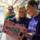 Image shows two women reading a card