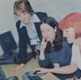 Image shows three women looking at a computer