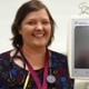 Image shows a doctor alongside a medical monitor.