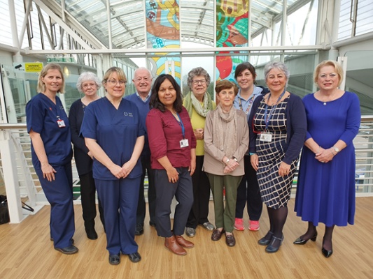 Image shows a group of people standing in a row